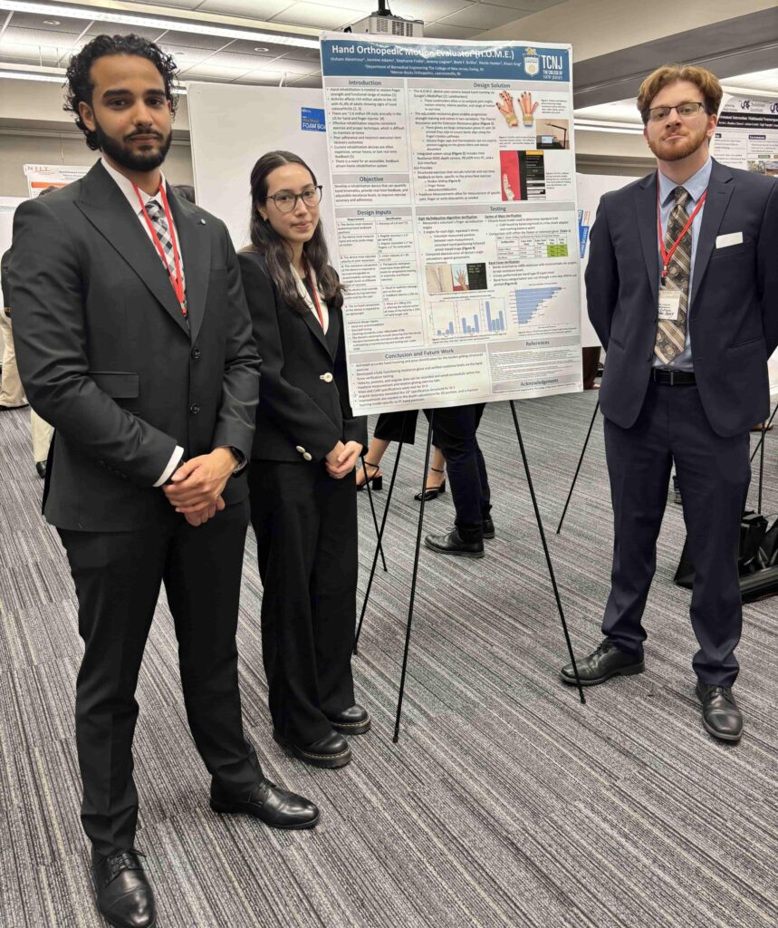 Three of four members are shown in the image standing next to the poster presented at NEBEC.