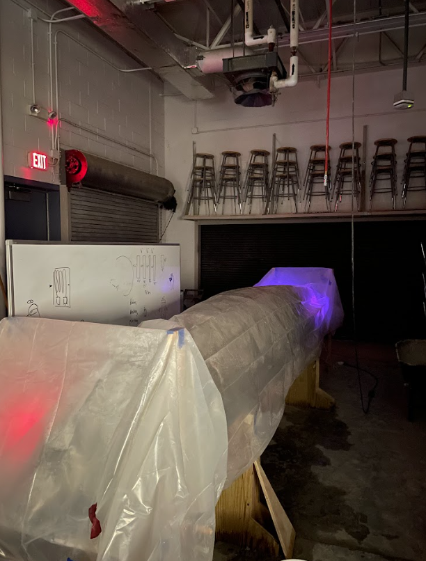 The canoe mold covered with plastic tarp.