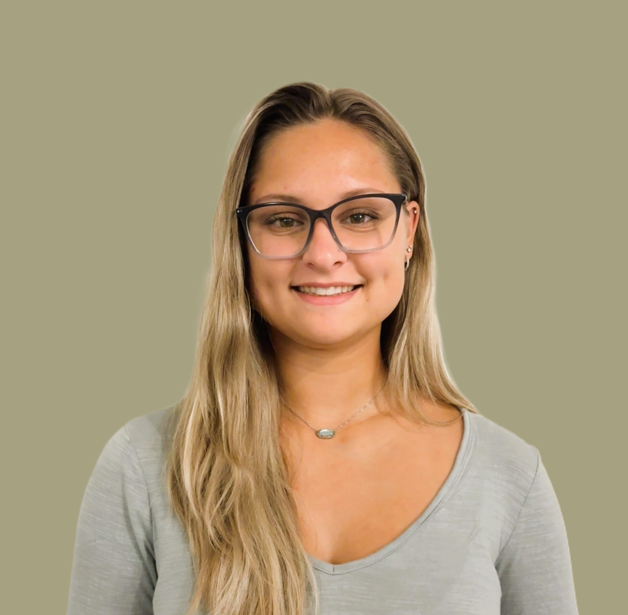 Headshot photo of Hannah Shepkosky smiling at the camera, wearing a gray shirt.